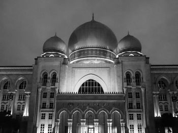 Low angle view of illuminated building against sky