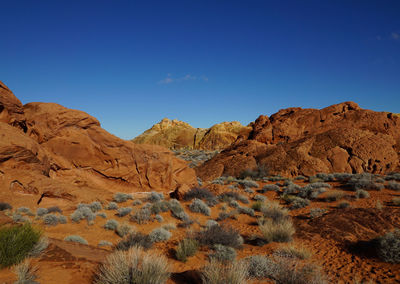 Scenic view of mountain range against blue sky