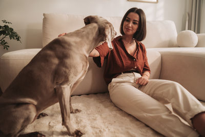 Side view of dog relaxing on bed at home