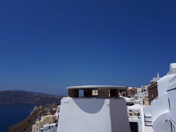 Buildings against clear blue sky