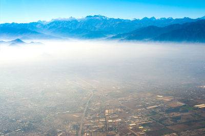 Aerial view of santiago de chile under a layer of smog with the andes mountain range in the back