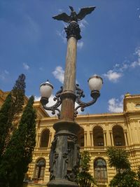 Low angle view of street light against sky