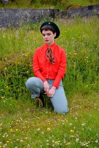 Young woman sitting on field