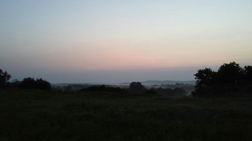 Scenic view of landscape against sky at sunset