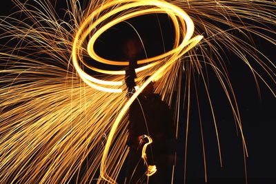 Blurred motion of man standing at night