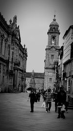 People walking in front of historical building