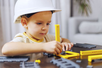 Portrait of cute girl playing with toy car