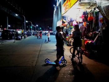 People on illuminated city at night