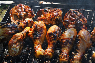 High angle view of chicken cooking on barbecue grill