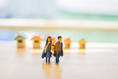 Close-up of figurines and model homes on table