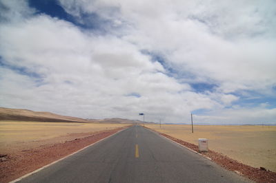 View of empty road against cloudy sky