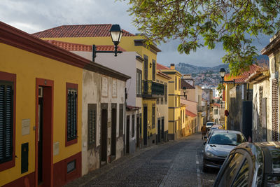 Street amidst buildings against sky in city