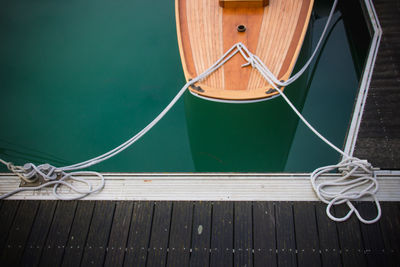 High angle view of ropes tied on wooden floor