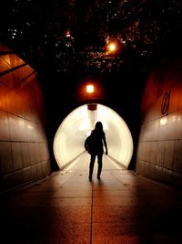 Blurred motion of man walking in tunnel