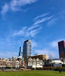 Buildings in city against blue sky