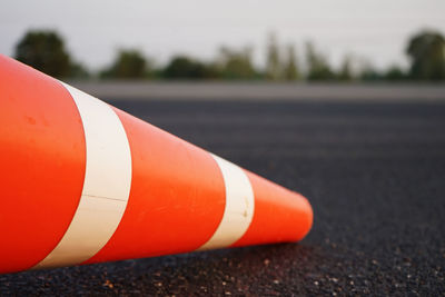 Close-up of red umbrella on road