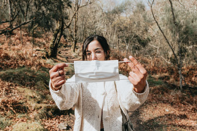 Portrait of smiling young woman using mobile phone