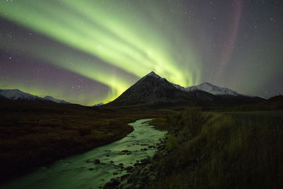 Scenic view of mountains against sky at night