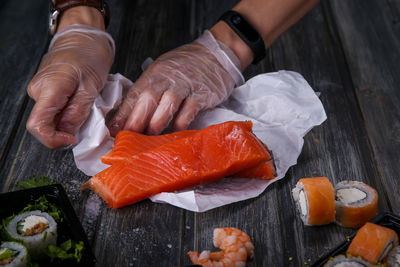 High angle view of person preparing fish on table
