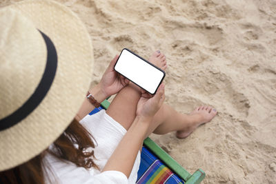 High angle view of man using mobile phone at beach