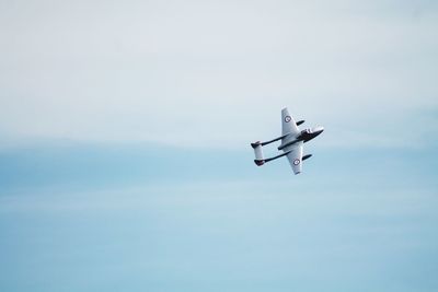 Low angle view of airplane flying in sky