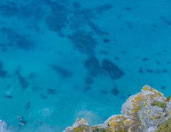 Steep cliffs and turquoise sea at the cape of good hope in south africa