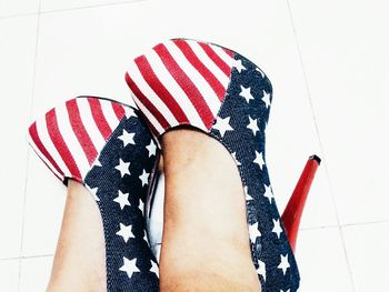 Low section of woman standing on white wall