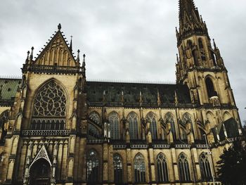 Low angle view of new cathedral against cloudy sky