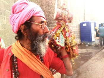 Sadhu with drum looking away