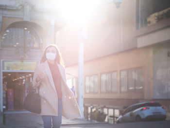 Woman walking on street in city