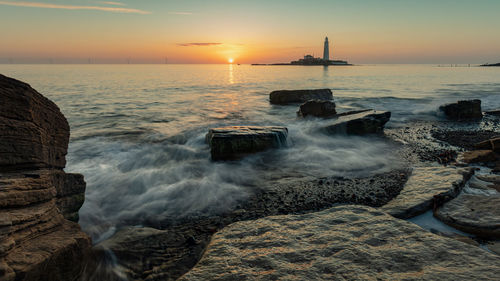 Scenic view of sea against sky during sunset