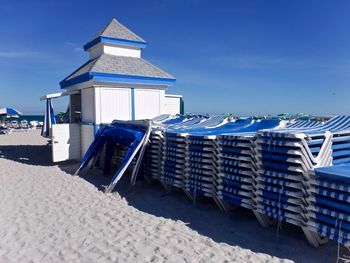 Built structure on beach against blue sky