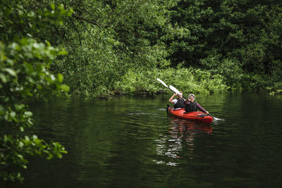 Senior man and woman learning kayaking in sea during training course