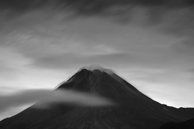 Low angle view of mountain against cloudy sky