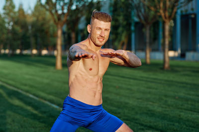 Portrait of young man exercising in park