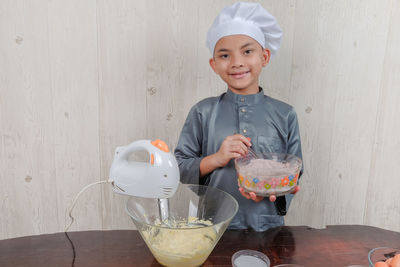 Boy mixing flour in bowl