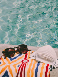 High angle view of sunglasses in swimming pool
