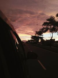 Car on road against sky during sunset