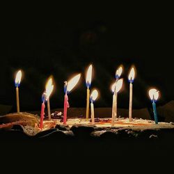 Lit candles in dark room