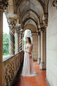 Woman standing in corridor of temple