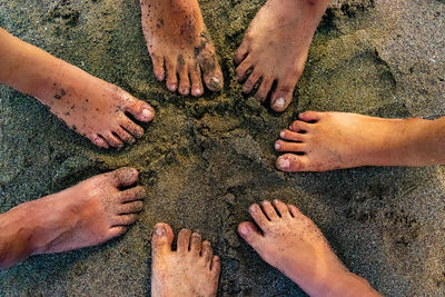 Low section of people standing on sand