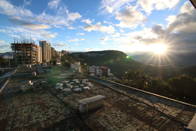 Buildings in city against sky during sunset