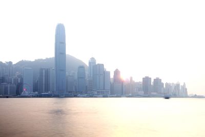 Modern buildings in city against clear sky