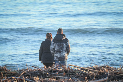 Rear view of couple standing on beach