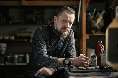 Portrait of man sitting at workshop