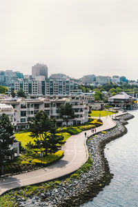 High angle view of road by buildings against sky