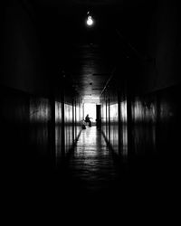 Man walking in illuminated tunnel