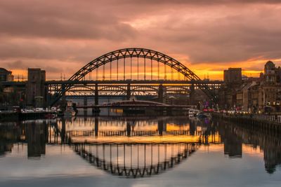 View of bridge over river against cloudy sky