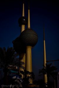 Low angle view of illuminated building against sky at night