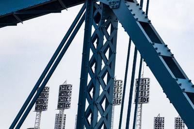 Low angle view of bridge and buildings against sky